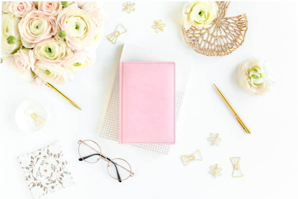 istock Workspace with diary, gold accessories, ranunculus flowers on white background. Home office desk. Top view feminine background. Flat lay, top view 1270682222