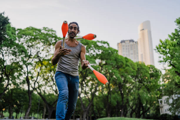 istock Man juggling with cones in park 1270682384
