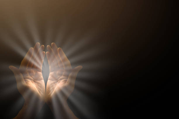 istock Light in the human hands in the dark 1270682972