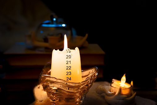 Christmas Advent Calendar on Burning Candle