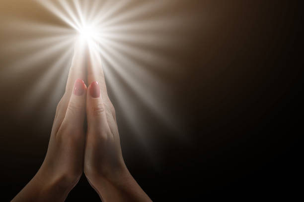istock Hands clasped. Close-up of hands clasped isolated on black 1270683354