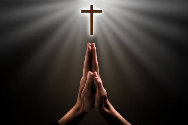 istock Hands clasped. Close-up of hands clasped isolated on black 1270683411