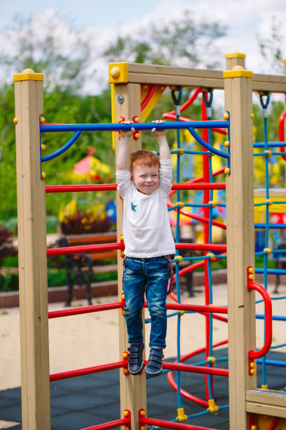istock Little boy playing on the playground in summer time 1270683796