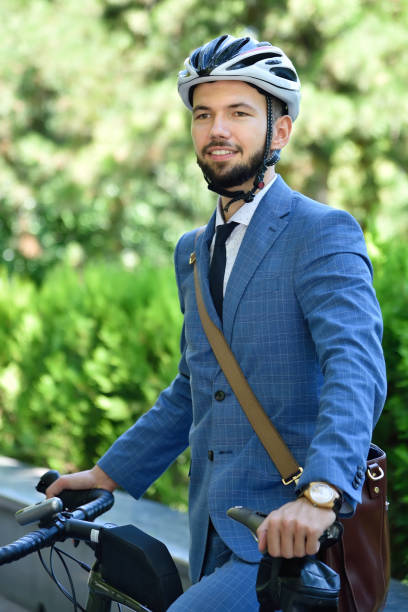 istock Happy bearded businessman in helmet with bicycle. 1270684502