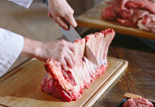 istock A man cook cuts meat with a knife in a restaurant. 1270686732