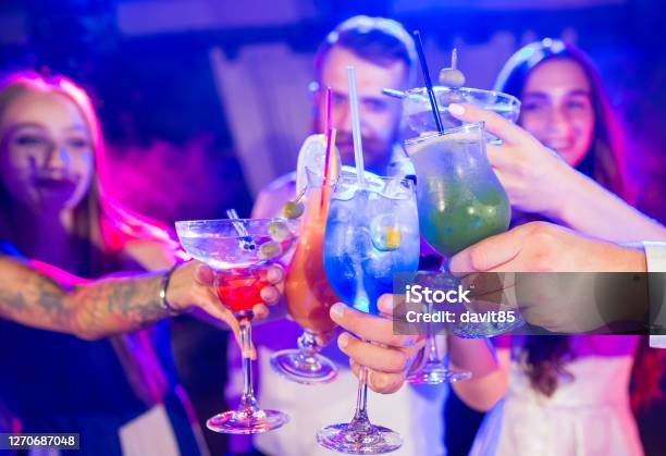 Young Friends Toasting With Drinks During Night Club Party Stock Photo - Download Image Now - iStock