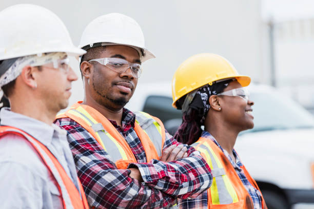 istock Three construction workers in hardhats and safety vests 1270689406