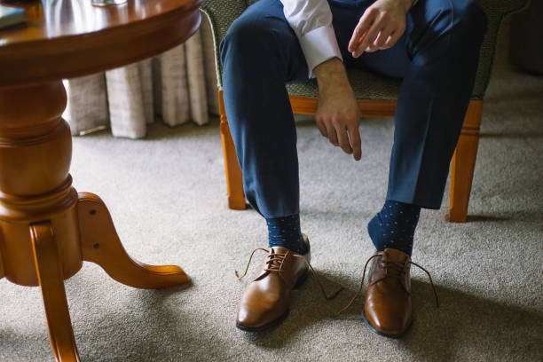 istock groom preparation, a man putting on shoes 1270689557