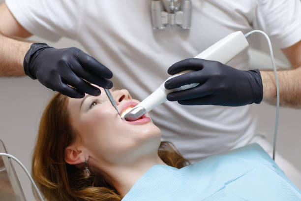 The dentist scans the patient's teeth with a 3d scanner stock photo