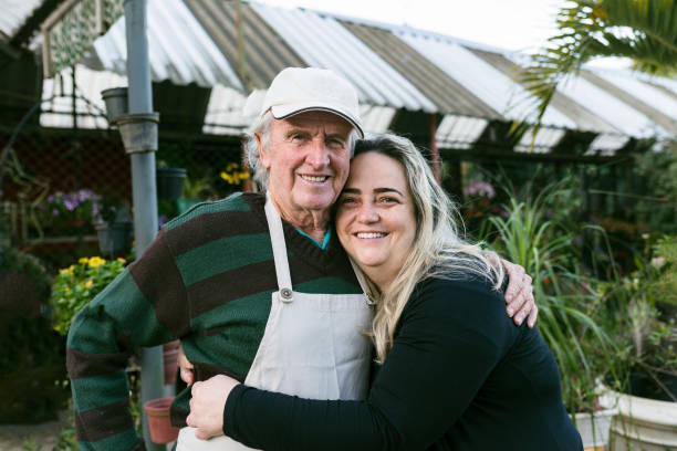 father and daughter in small flower and plant business - 5943 imagens e fotografias de stock