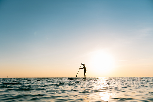 Woman paddle boarding at the Outer Banks