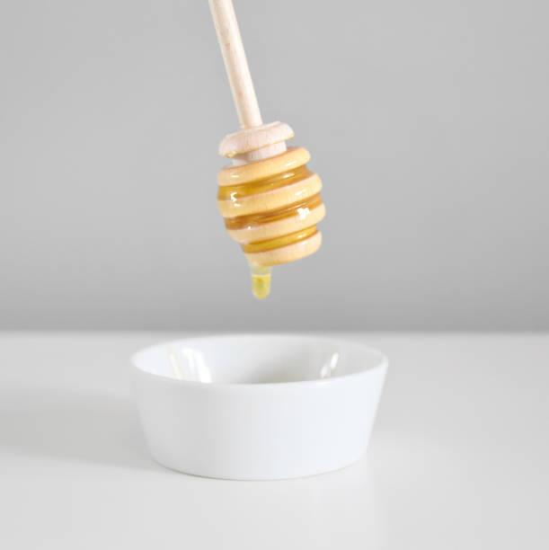 istock Honey dipper dripping organic honey 1270691715