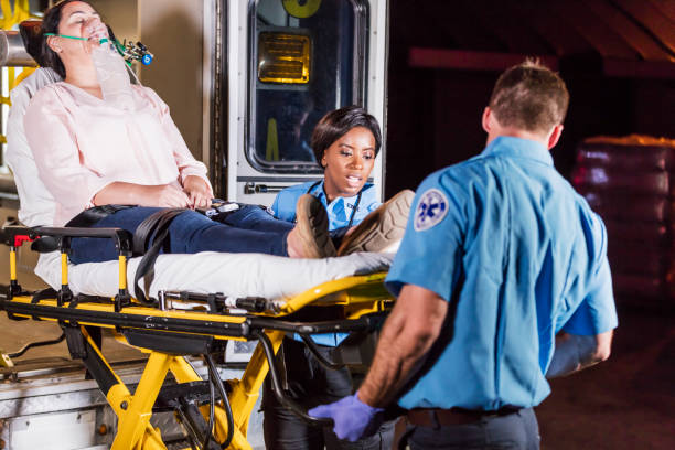 istock Paramedics loading woman on stretcher into ambulance 1270691784