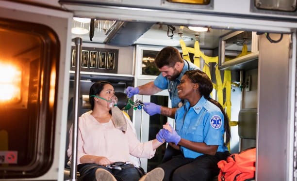 Paramedics helping woman in ambulance