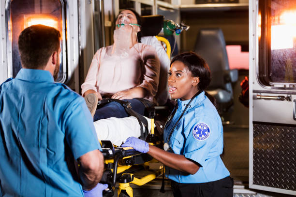 istock Paramedics loading woman on stretcher into ambulance 1270691837