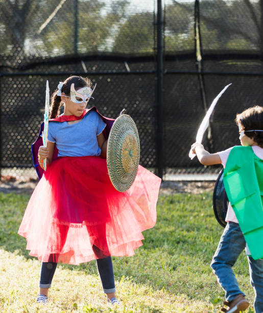 istock Hispanic children in superhero costumes, rivalry 1270693710