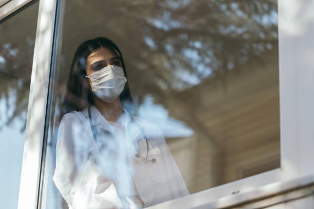 istock Female doctor looking through a window 1270693817