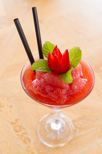 Strawberry cocktail with mint leaves in a glass. Upper point of view; top view