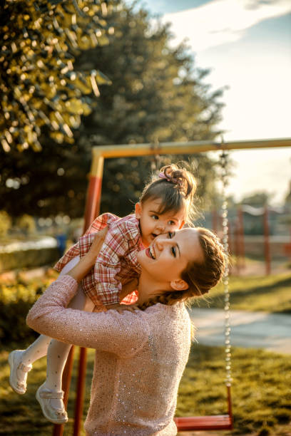 istock Mom and daughter having fun at outdoors playground 1270697649