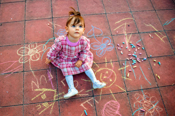 istock Little Girl Playing At Playground Outdoors In Summer 1270697738