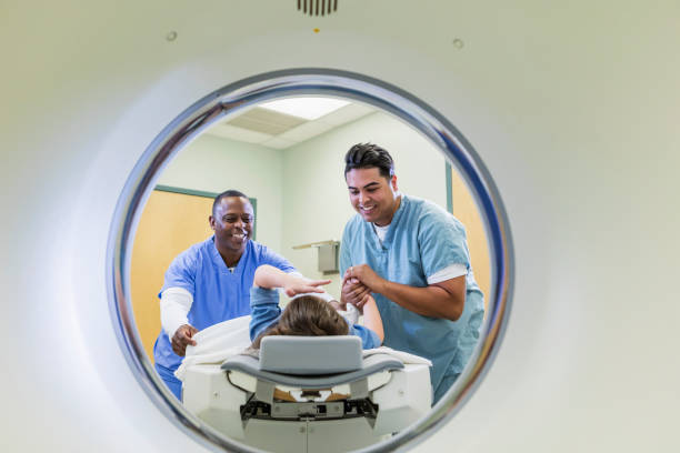 Technologist talking to girl getting CT scan