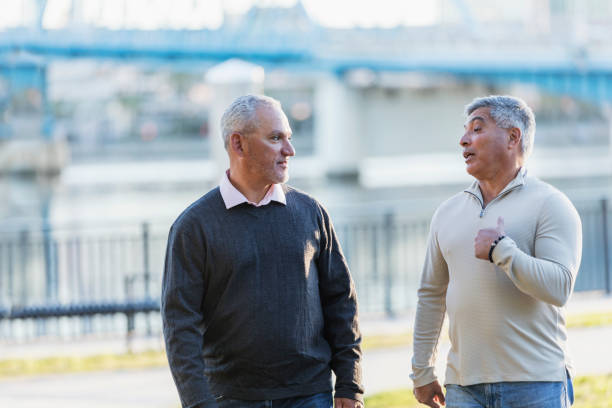 istock Hispanic men walking and conversing on city waterfront 1270699987
