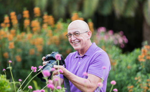istock Mature man with camera, photographing nature 1270701858