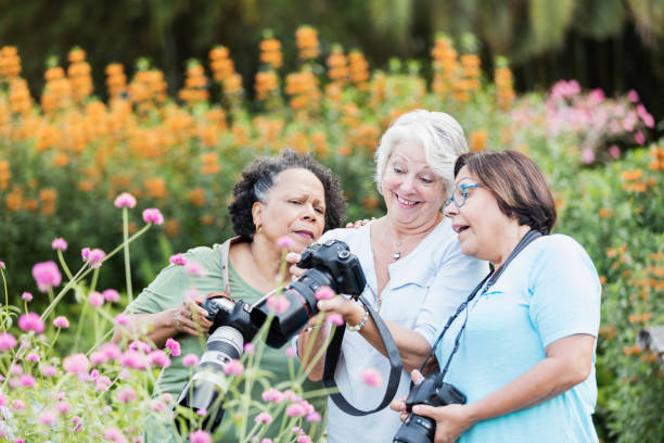 istock Three senior women taking photos in garden 1270702403
