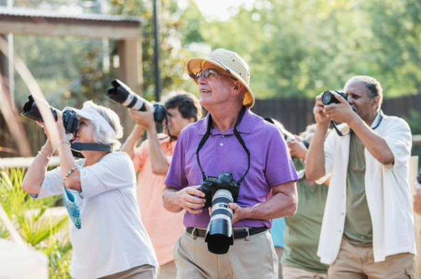 istock Mature man with senior tour group, taking photos 1270703350