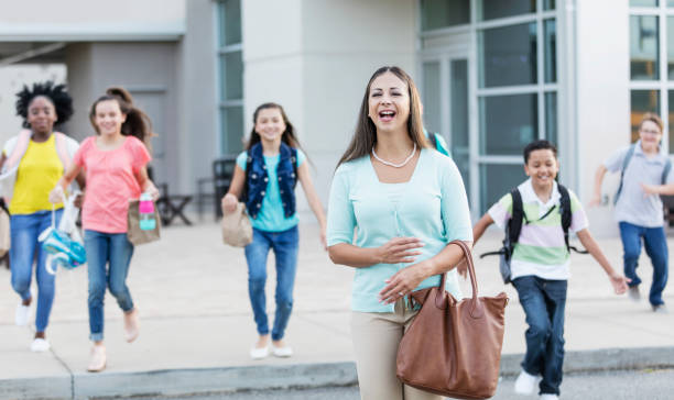 istock Hispanic teacher standing outside middle school 1270703993