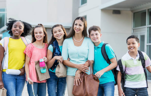istock Hispanic teacher and middle school students outdoors 1270703995