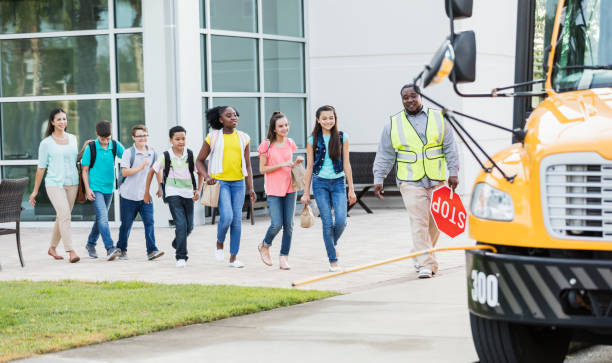 istock Students and teacher boarding school bus 1270704041