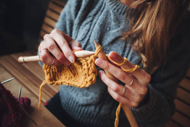 istock Close up on woman's hands knitting 1270707209