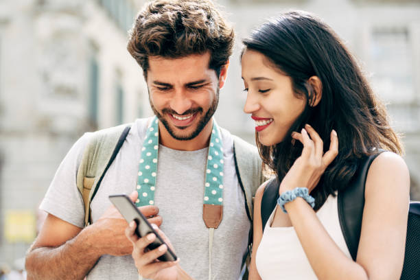 istock Young tourists pausing to check smart phone in Barcelona 1270707220