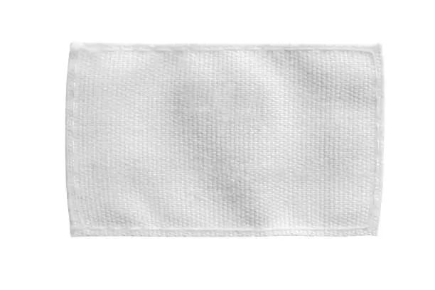 Photo of White blank laundry care clothes label isolated on white background