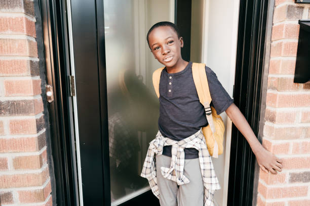 istock Elementary age student going back to school. He is closing the house door behind him 1270707482