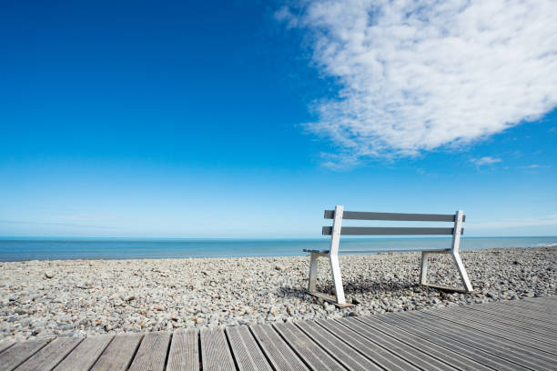 istock Wooden bench over clean beach and ocean background 1270707578