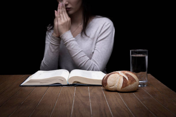 Young woman doing fasting and prayer in an interior Young woman doing fasting and prayer in an interior fasting stock pictures, royalty-free photos & images