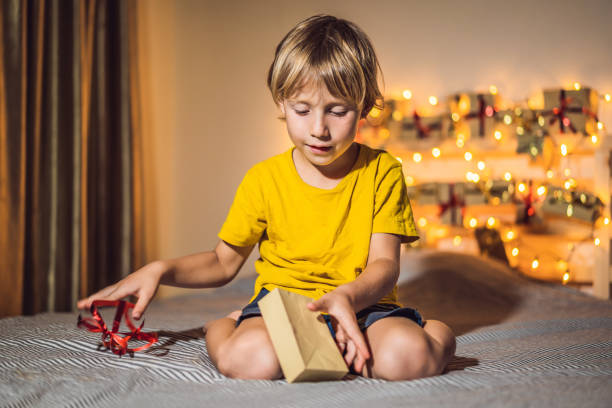 istock The boy opens a gift from the advent calendar 1270712680