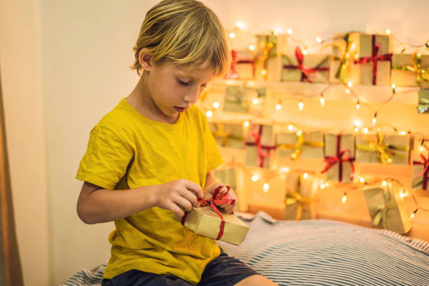 istock The boy opens a gift from the advent calendar 1270712683