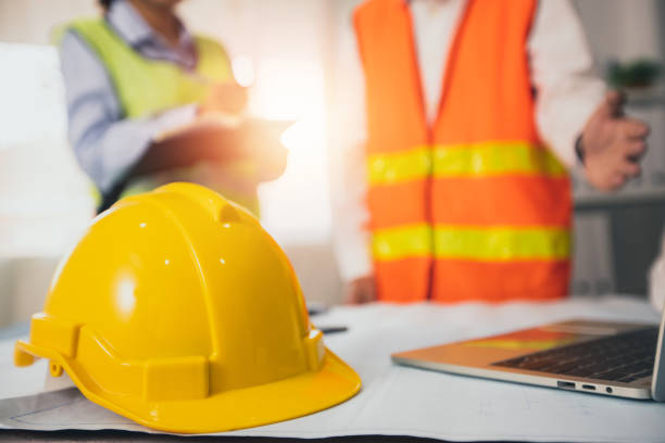 istock yellow helmet of construction worker on meeting table  in office with engineer planning background 1270715857