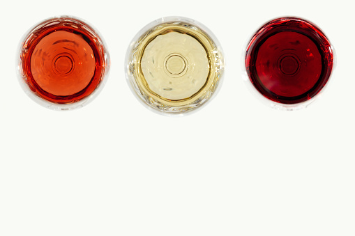 Assorted wine in glass. Red, rose and white wine top view on light background. Bar, winery, degustation concept.