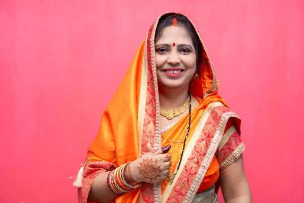 Portrait of an middle age woman of Indian origin wearing traditional sari.
