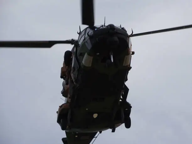 Camouflaged Army Blackhawk helicopters involved in training exercises.