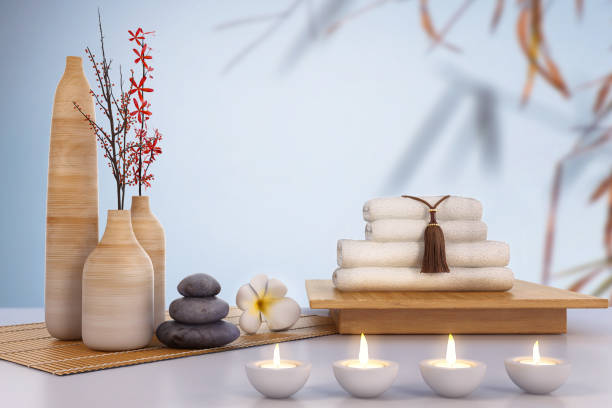 istock massage spa set with bed background. Aroma therapy, candle and fragrant oil set on side table, spa massage bed, Concept image for relaxation with copy space for text. 3d illustration. 1270730810