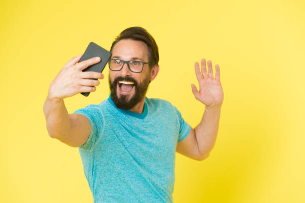istock User friendly concept. Man excited about mobile phone opportunities. Hipster cheerful use smartphone. Man happy user of modern smartphone. Stay in touch with modern smartphone. Join online community 1270731643
