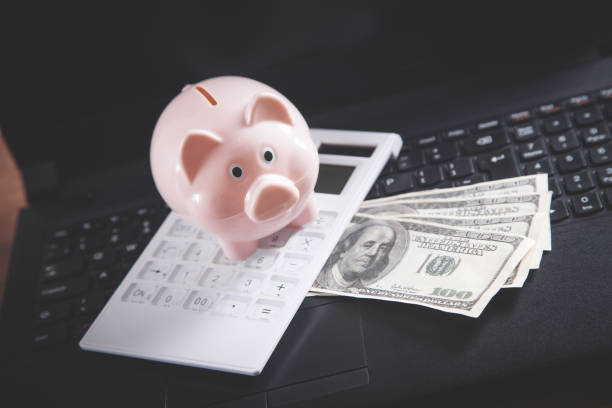 istock Piggy bank on laptop keyboard. Savings concept 1270732432