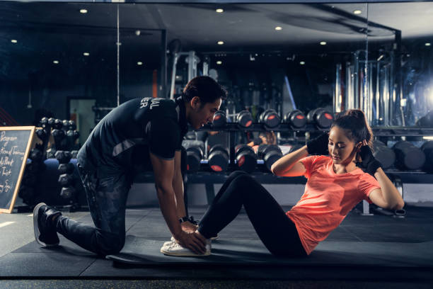 istock Personal trainer to practice sit-ups in the gym 1270732520