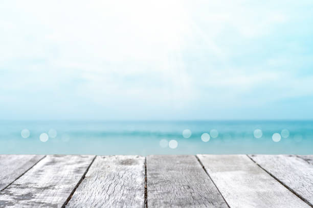istock Selective focus of old wood table with blur beautiful beach background for display your product. 1270732632