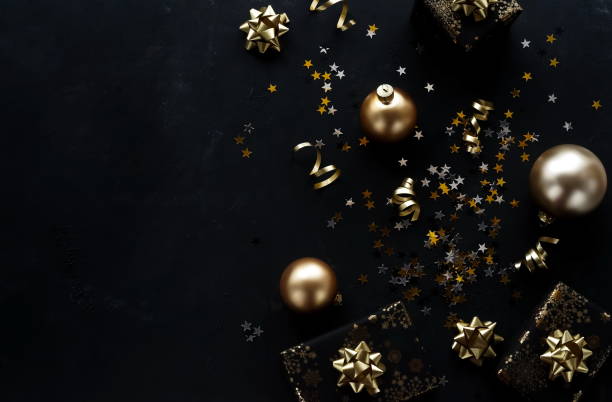 istock Christmas background with gold  decorations, stars,  balls, gift boxes on black vintage backdrop. top view. copy space 1270734995